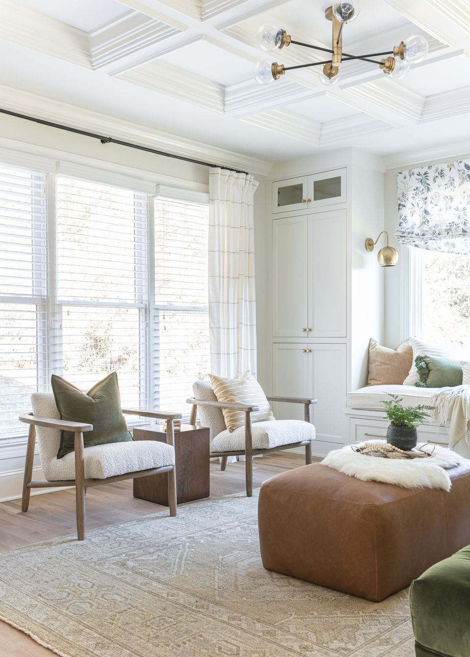 Pair of oak lounge chairs beside tall windows under a coffered ceiling