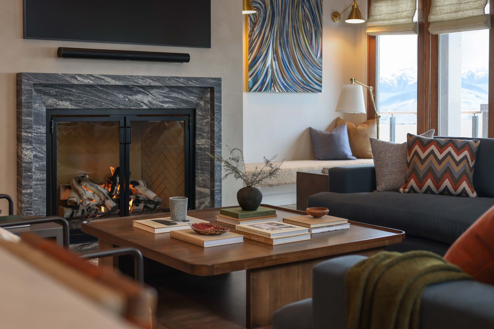 Living room with a marble-surround fireplace, walnut coffee table and navy sofa