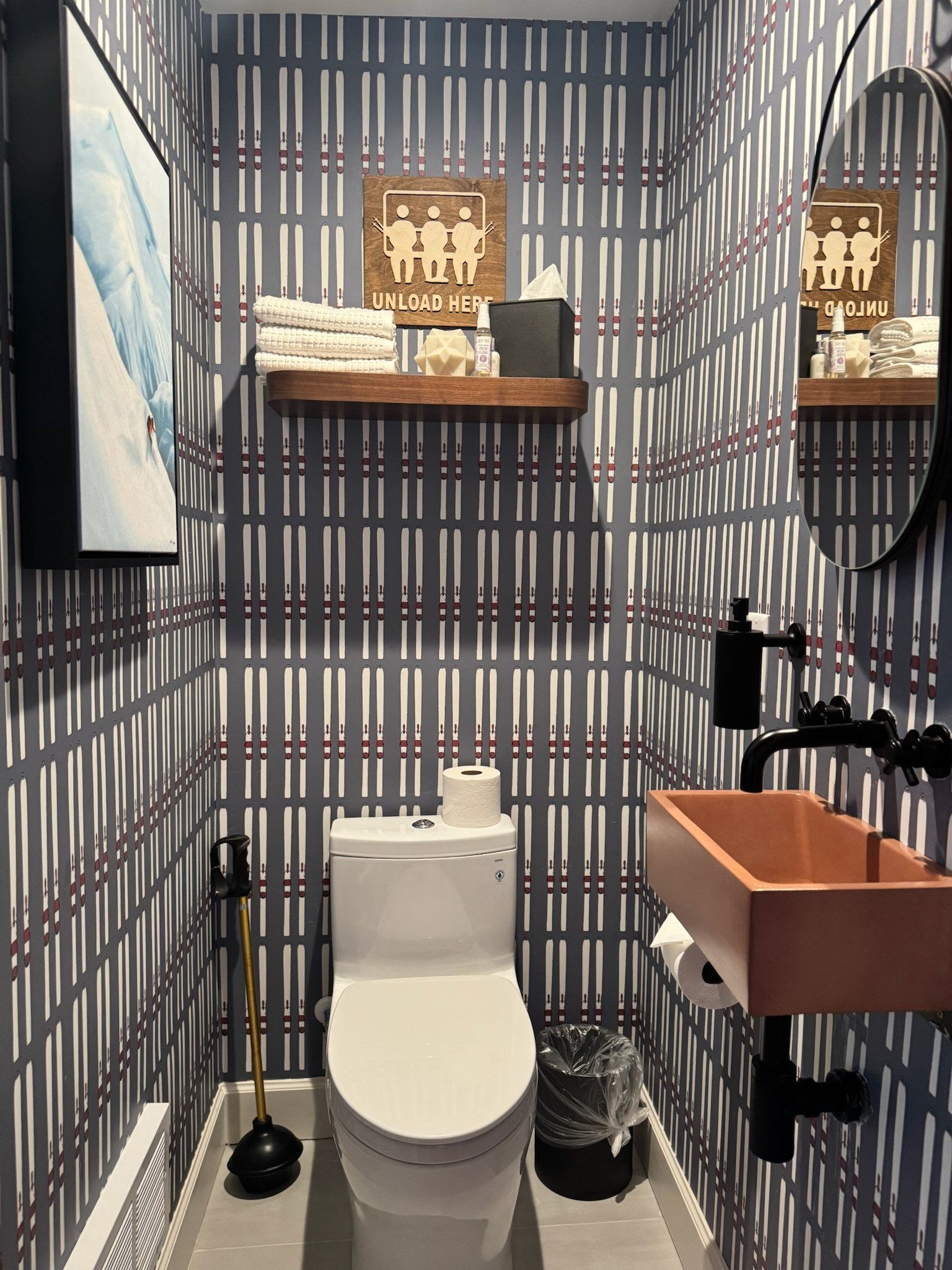 Powder bath with tartan wallpaper, a copper trough sink and a vintage ski-lodge sign