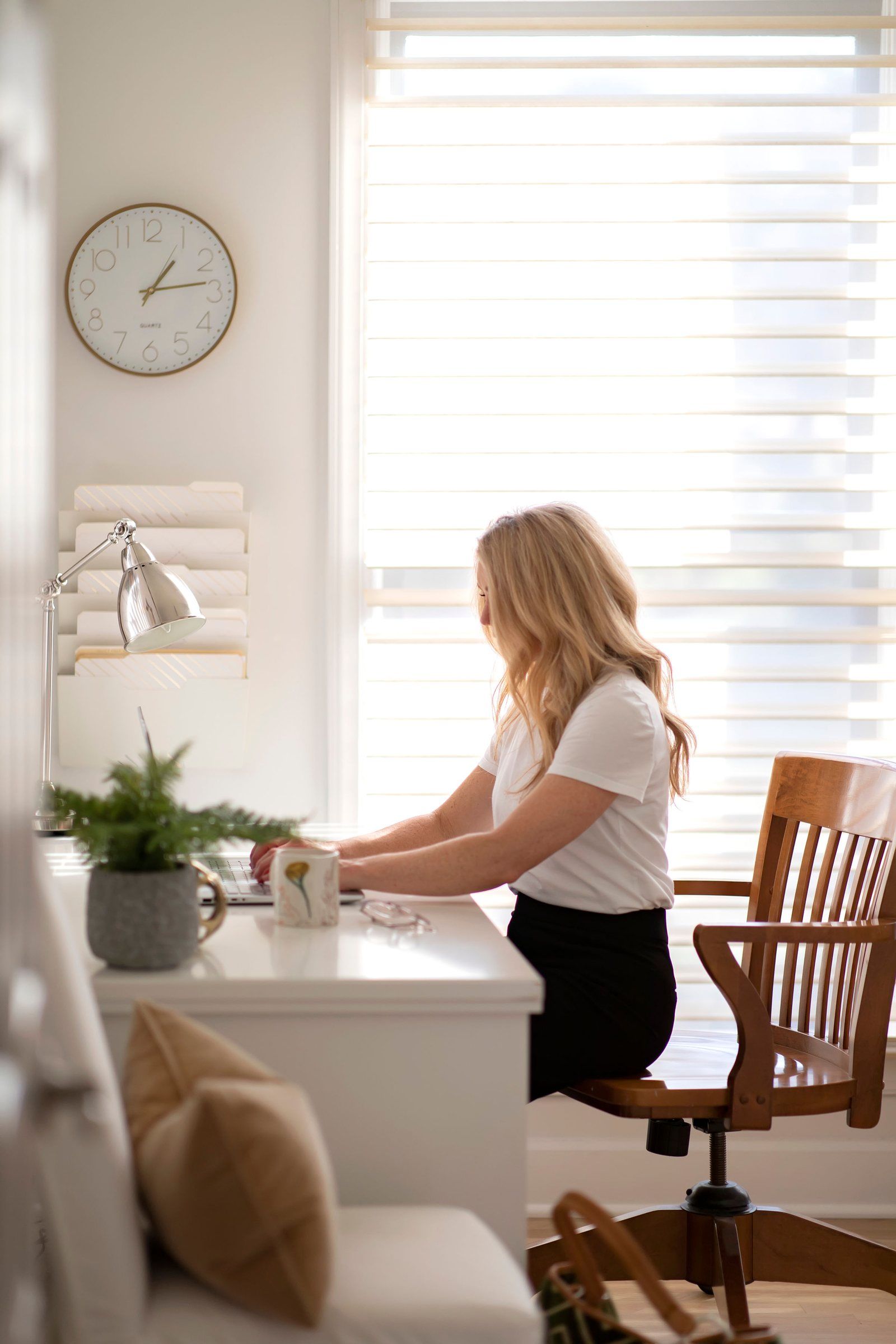 Joni at her desk in the studio, working on a client's plans